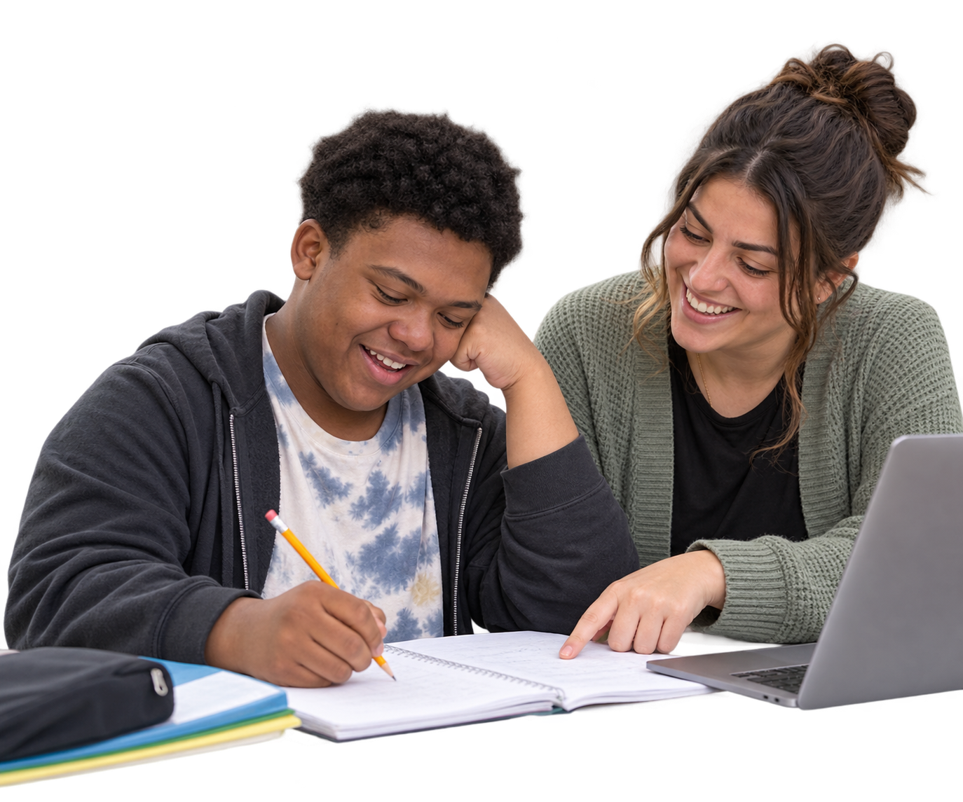 A learner writes in a notebook with support from a tutor